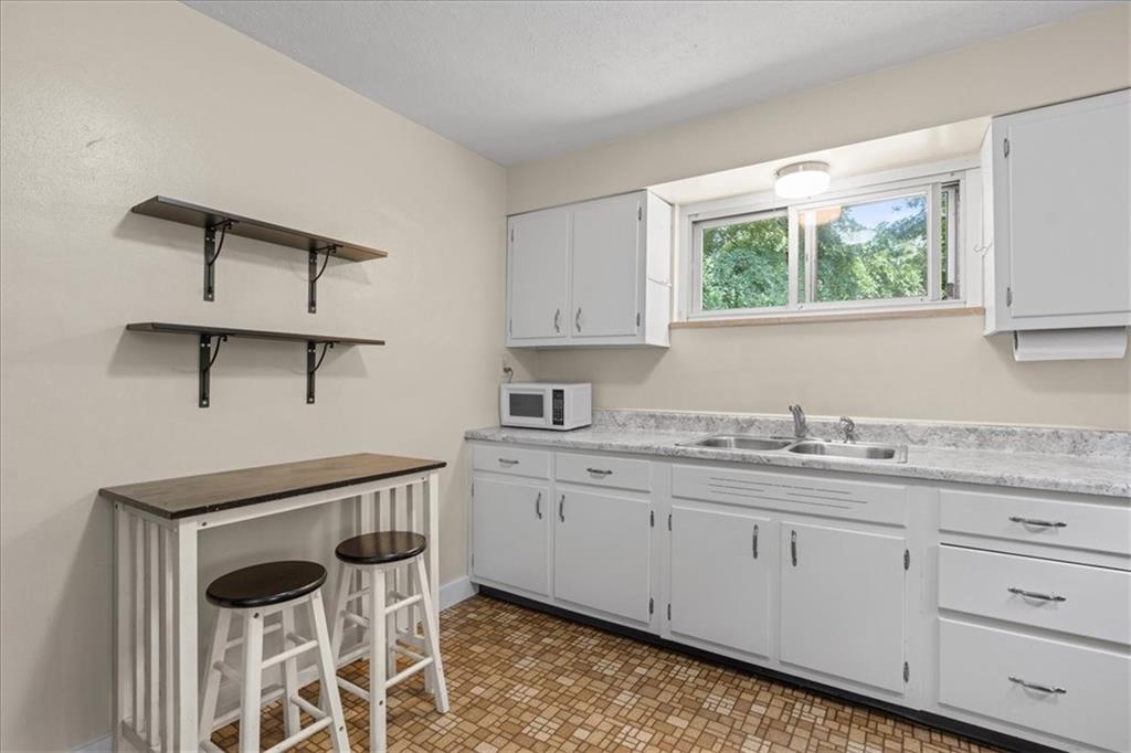 553 Fairoaks Street McKees Rocks, PA 15136 - Photo 3 of 22 a kitchen with granite countertop white cabinets and window