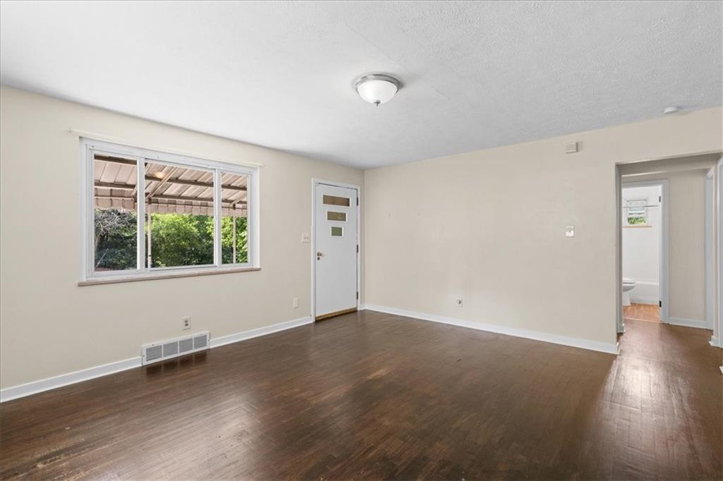 553 Fairoaks Street McKees Rocks, PA 15136 - Photo 5 of 22 an empty room with wooden floor and windows