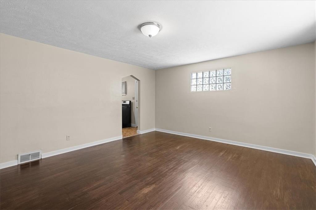 553 Fairoaks Street McKees Rocks, PA 15136 - Photo 7 of 22 an empty room with wooden floor and windows