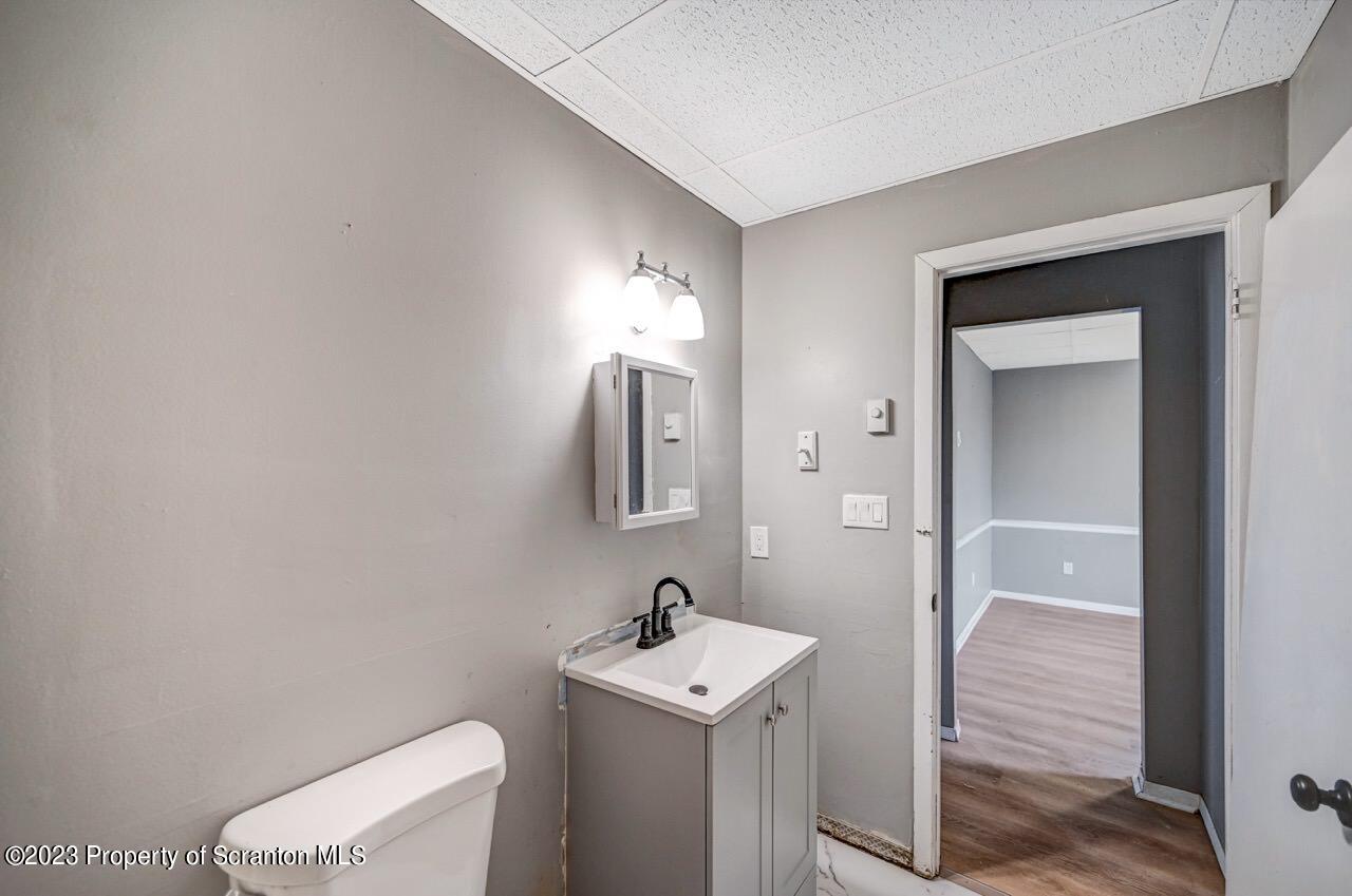 314 West Market Street, Unit 8 Scranton, PA 18508 - Photo 15 of 35 a bathroom with a sink a toilet and mirror