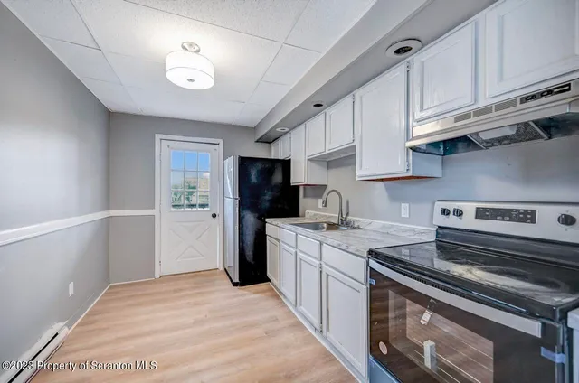 an empty room with windows and closet