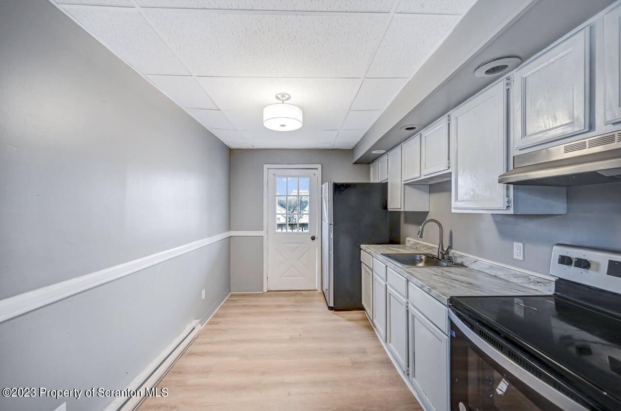 314 West Market Street, Unit 8 Scranton, PA 18508 - Photo 19 of 35 a kitchen with stainless steel appliances granite countertop a sink stove and refrigerator