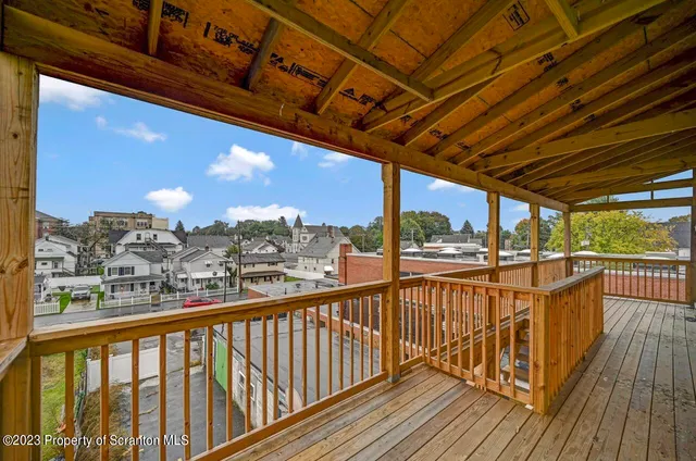 a view of staircase with wooden floor and white walls