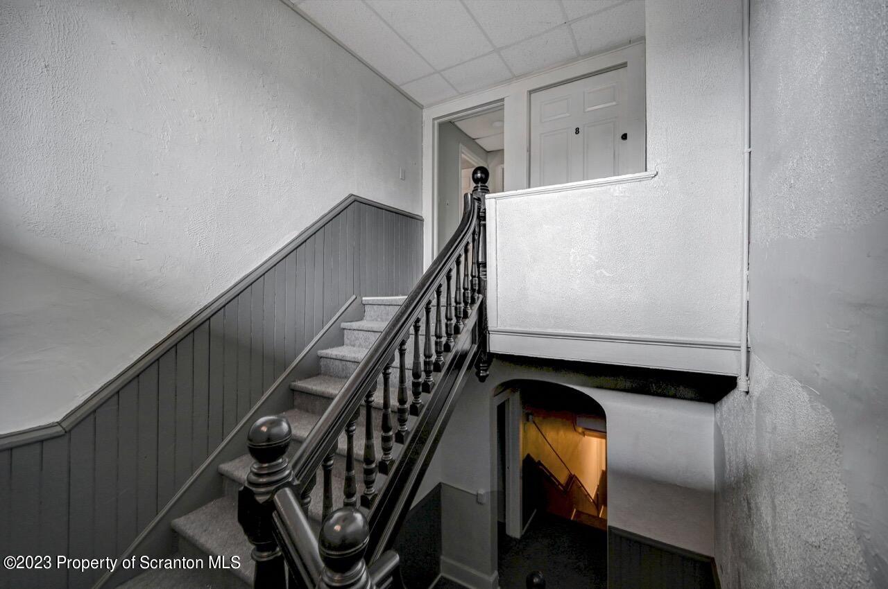 314 West Market Street, Unit 8 Scranton, PA 18508 - Photo 8 of 35 a view of staircase with wooden floor and white walls