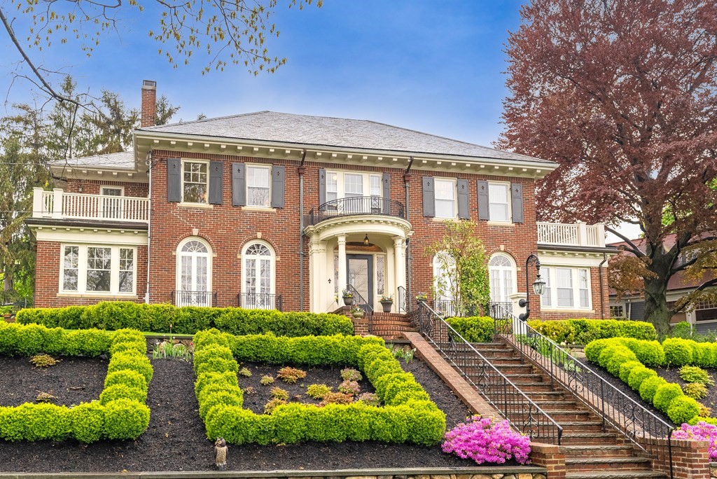 a front view of a house with a garden