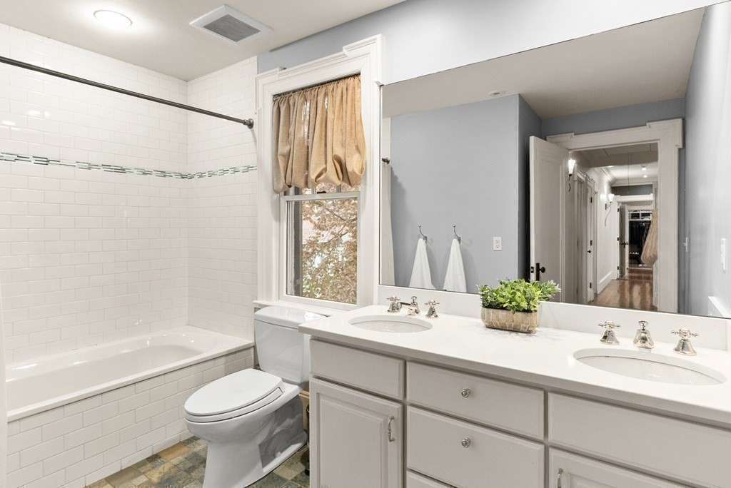 37 Colbourne Crescent Brookline, MA 02445 - Photo 18 of 29 a bathroom with a sink a toilet and a large mirror
