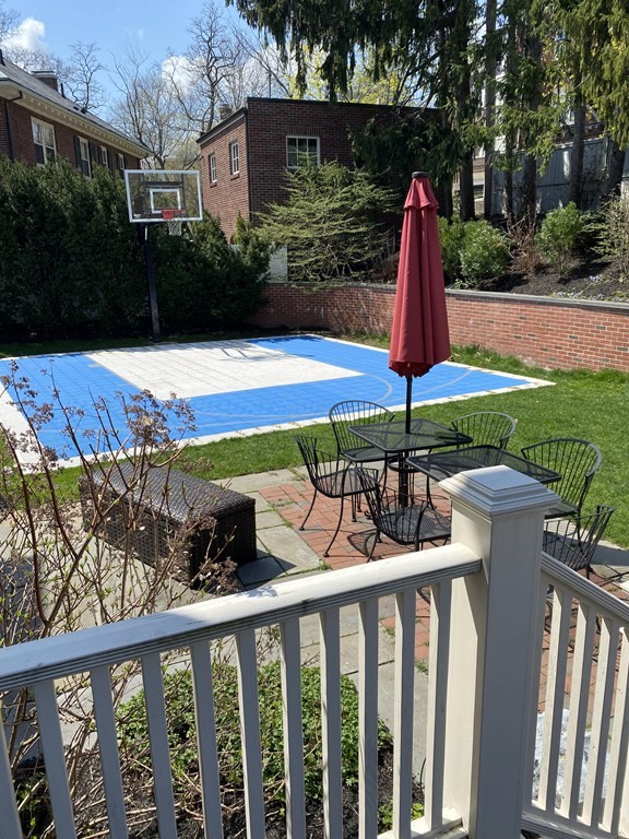 37 Colbourne Crescent Brookline, MA 02445 - Photo 29 of 29 a view of swimming pool with a table and chairs under an umbrella