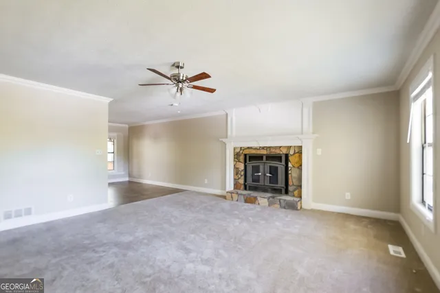 an empty room with a fireplace and a window
