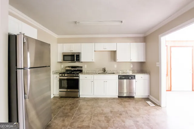 a kitchen with a refrigerator stove and microwave