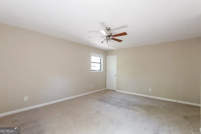 a view of room with a ceiling fan and window