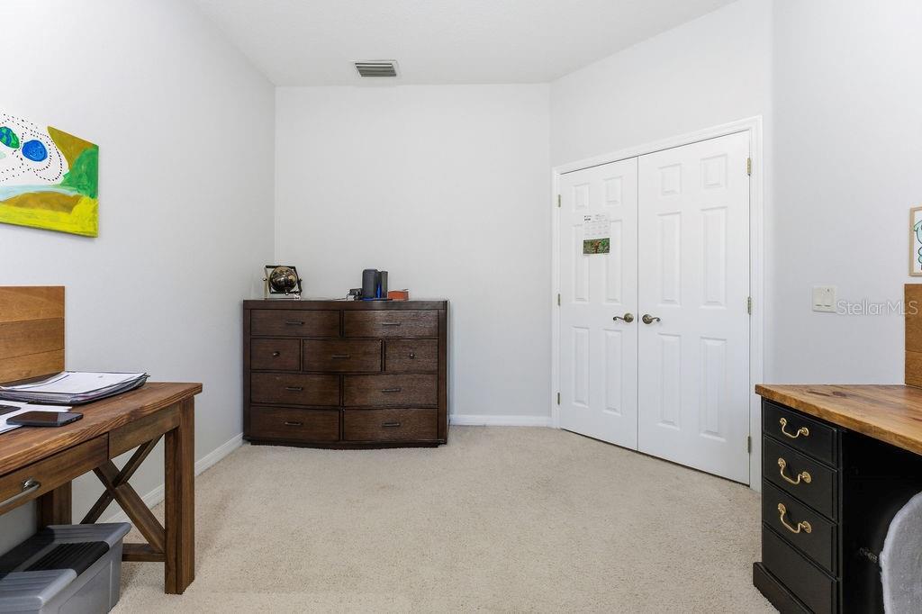 1338 Southwest 161st Place Ocala, FL 34473 - Photo 18 of 88 a room that has a dresser and a chair in it