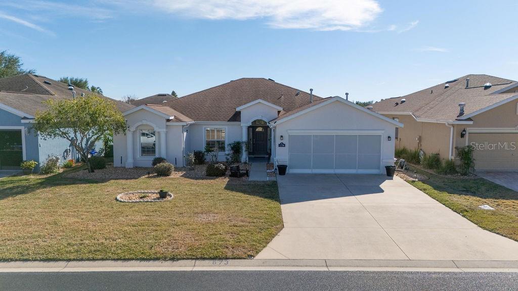 1338 Southwest 161st Place Ocala, FL 34473 - Photo 41 of 88 a front view of a house with yard and parking