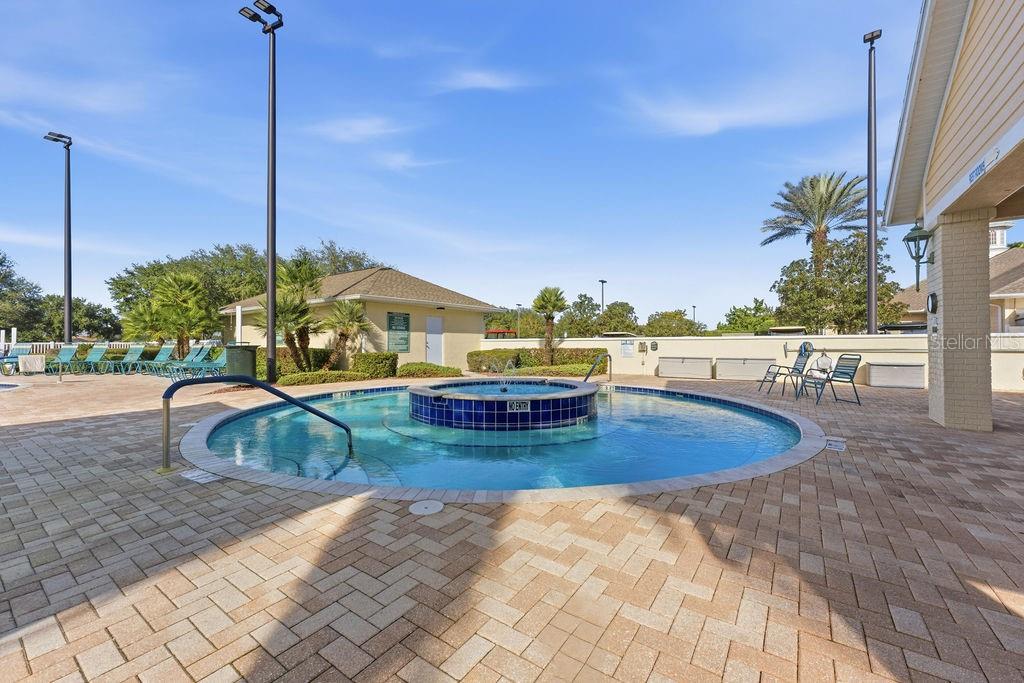 1338 Southwest 161st Place Ocala, FL 34473 - Photo 62 of 88 a view of a swimming pool with a lounge chairs