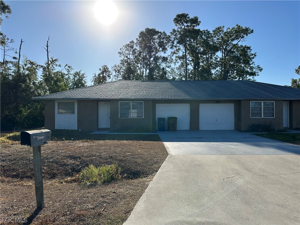 2429 George Avenue South, Unit 2431 Lehigh Acres, FL 33973 - Photo 1 of 16 a front view of a house with garden