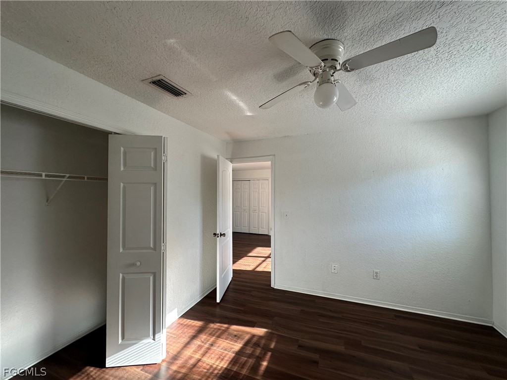 2429 George Avenue South, Unit 2431 Lehigh Acres, FL 33973 - Photo 16 of 16 a bedroom with a bed and a ceiling fan