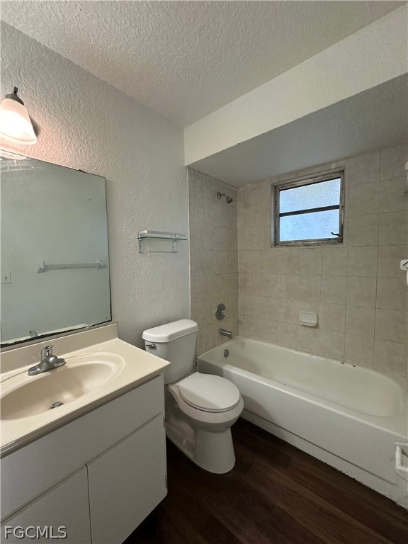 2429 George Avenue South, Unit 2431 Lehigh Acres, FL 33973 - Photo 10 of 16 a bathroom with a granite countertop toilet a sink and bathtub