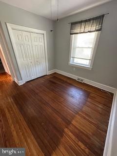 209 Ash Road Wallingford, PA 19086 - Photo 22 of 29 an empty room with wooden floor and windows