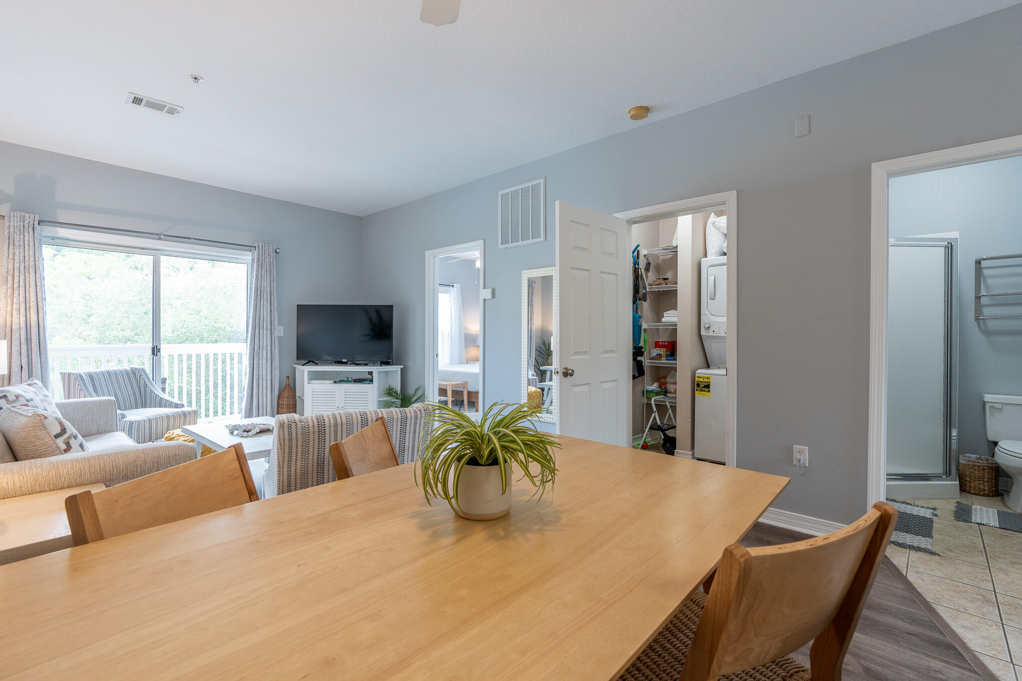 34 Heron's Watch Way, Unit 5205 Santa Rosa Beach, FL 32459 - Photo 23 of 50 a dining room with furniture a large window and a flat screen tv