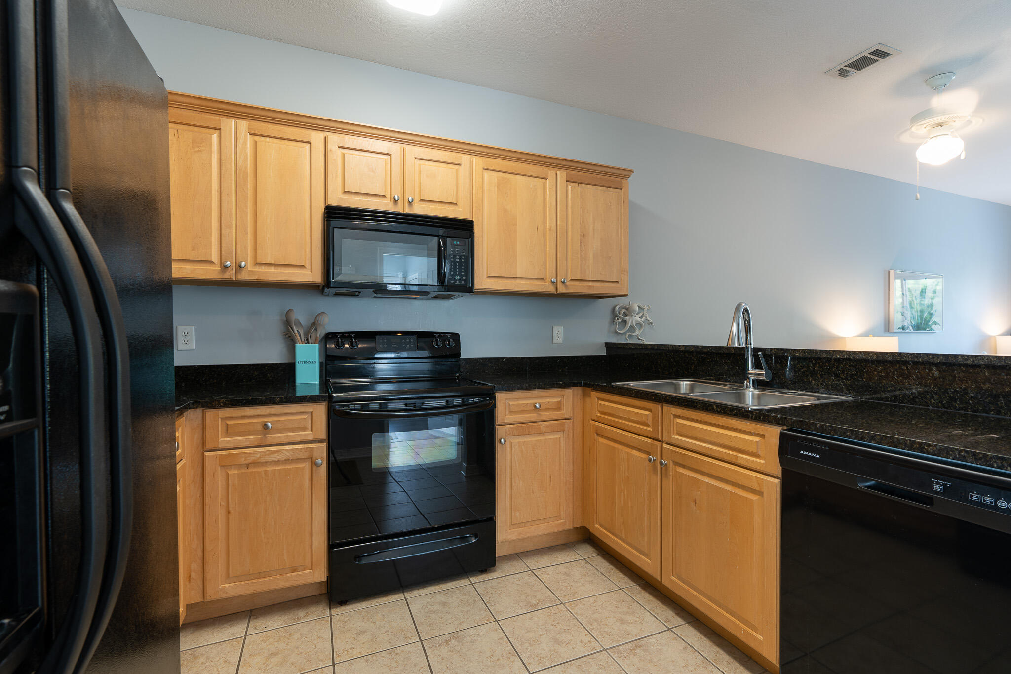 34 Heron's Watch Way, Unit 5205 Santa Rosa Beach, FL 32459 - Photo 5 of 50 a kitchen with stainless steel appliances granite countertop a stove sink and cabinets