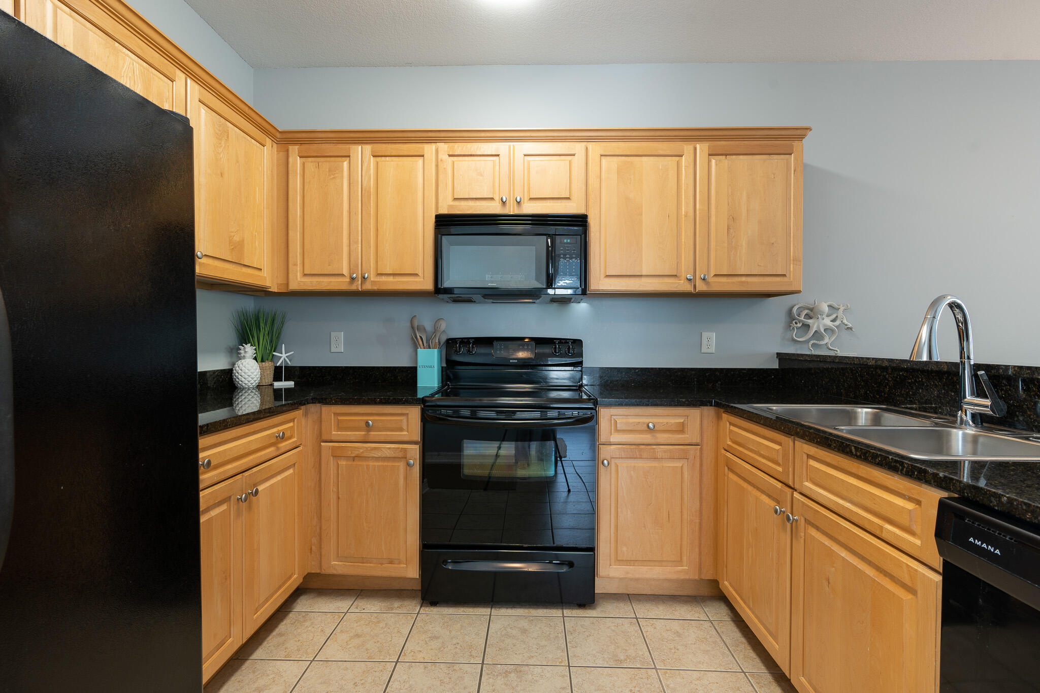 34 Heron's Watch Way, Unit 5205 Santa Rosa Beach, FL 32459 - Photo 6 of 50 a kitchen with stainless steel appliances granite countertop a stove sink and cabinets
