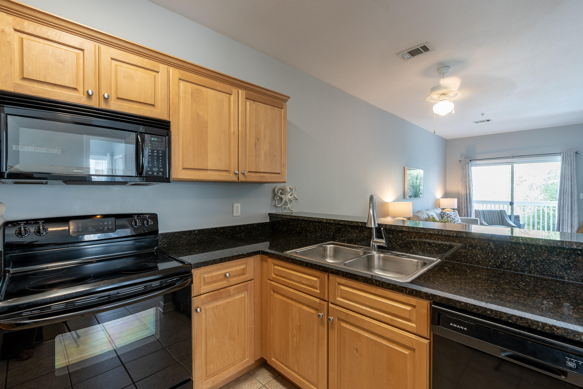 34 Heron's Watch Way, Unit 5205 Santa Rosa Beach, FL 32459 - Photo 9 of 50 a kitchen with stainless steel appliances granite countertop a sink stove and microwave