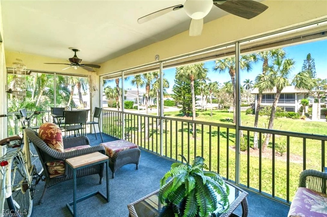 1549 Sandpiper Street, Unit 34 Naples, FL 34102 - Photo 12 of 15 a balcony with furniture and a potted plant