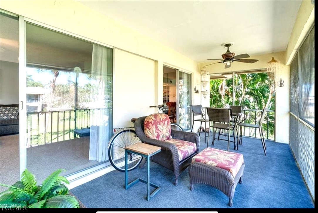 1549 Sandpiper Street, Unit 34 Naples, FL 34102 - Photo 13 of 15 a living room with furniture and a large window