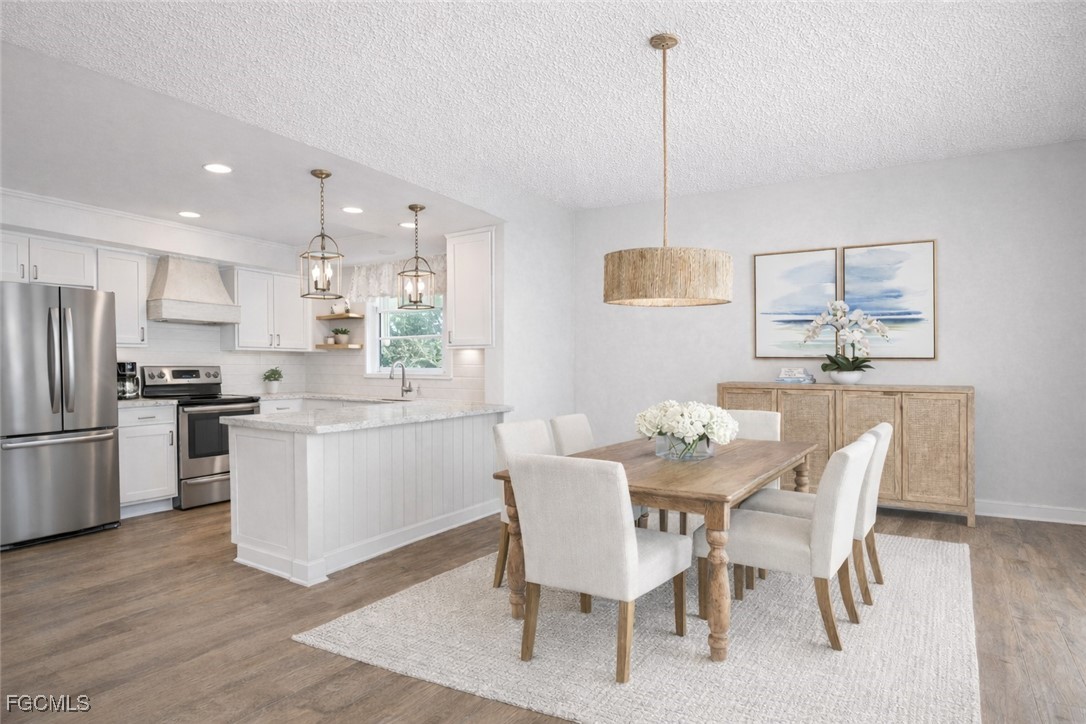 1549 Sandpiper Street, Unit 34 Naples, FL 34102 - Photo 4 of 15 a kitchen with a dining table chairs and refrigerator