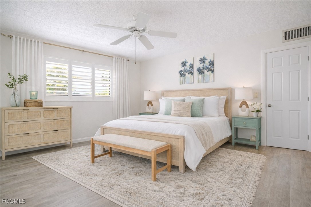 1549 Sandpiper Street, Unit 34 Naples, FL 34102 - Photo 8 of 15 a bedroom with a bed and a window