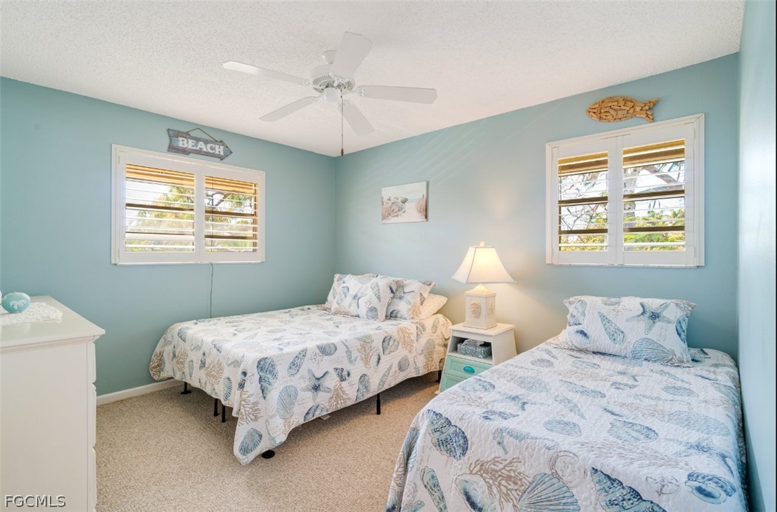 1549 Sandpiper Street, Unit 34 Naples, FL 34102 - Photo 9 of 15 a bedroom with two beds and a window