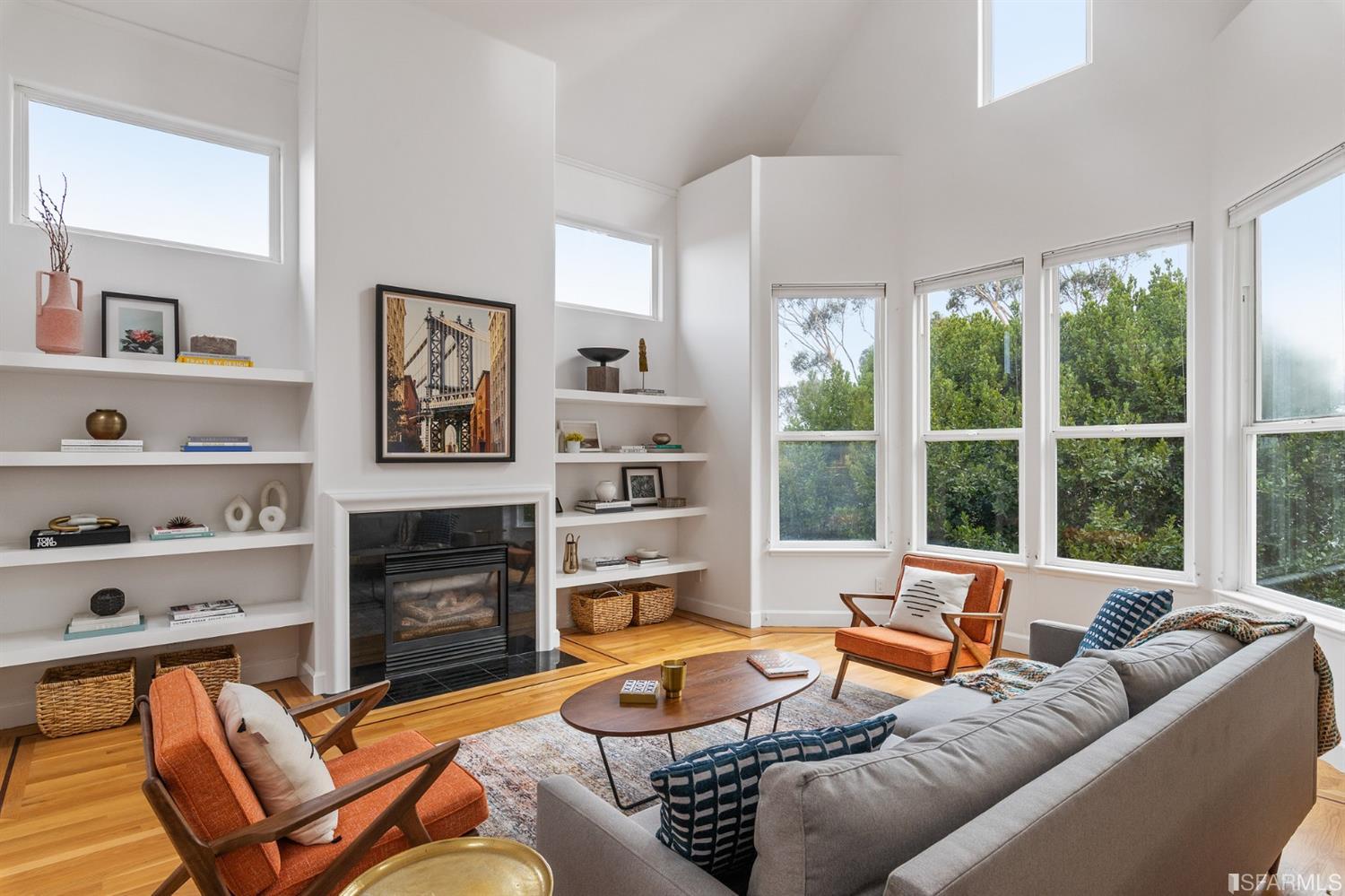 a living room with furniture fireplace and a window