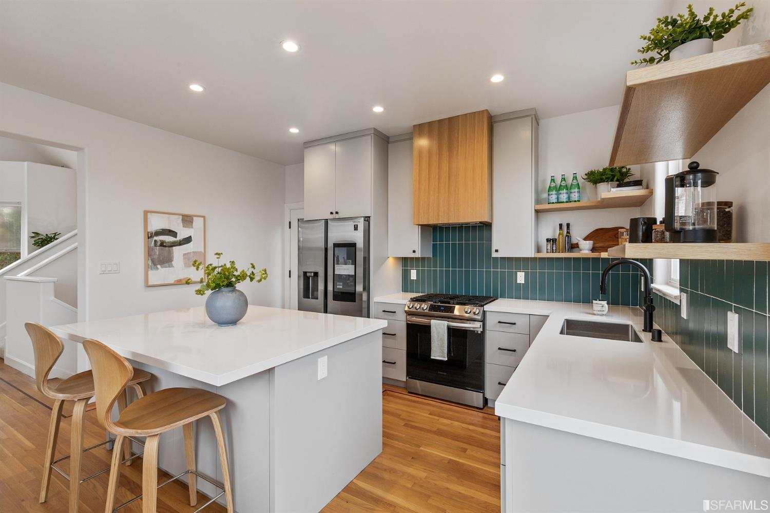 8 Joy Street San Francisco, CA 94110 - Photo 13 of 42 a kitchen with stainless steel appliances granite countertop a sink dishwasher stove top oven and refrigerator with wooden floor