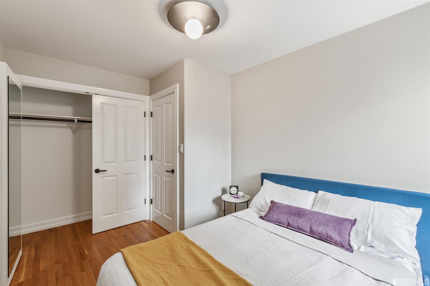 8 Joy Street San Francisco, CA 94110 - Photo 39 of 42 a bedroom with a bed and a chandelier