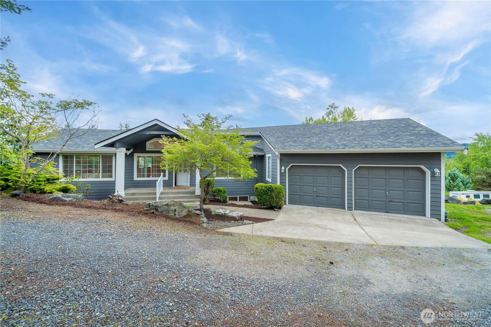 a front view of a house with a yard and garage