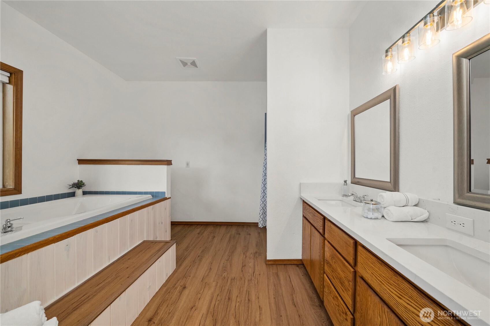 183 Dow Ridge Drive North Eatonville, WA 98328 - Photo 21 of 40 a spacious bathroom with a granite countertop sink and a large mirror