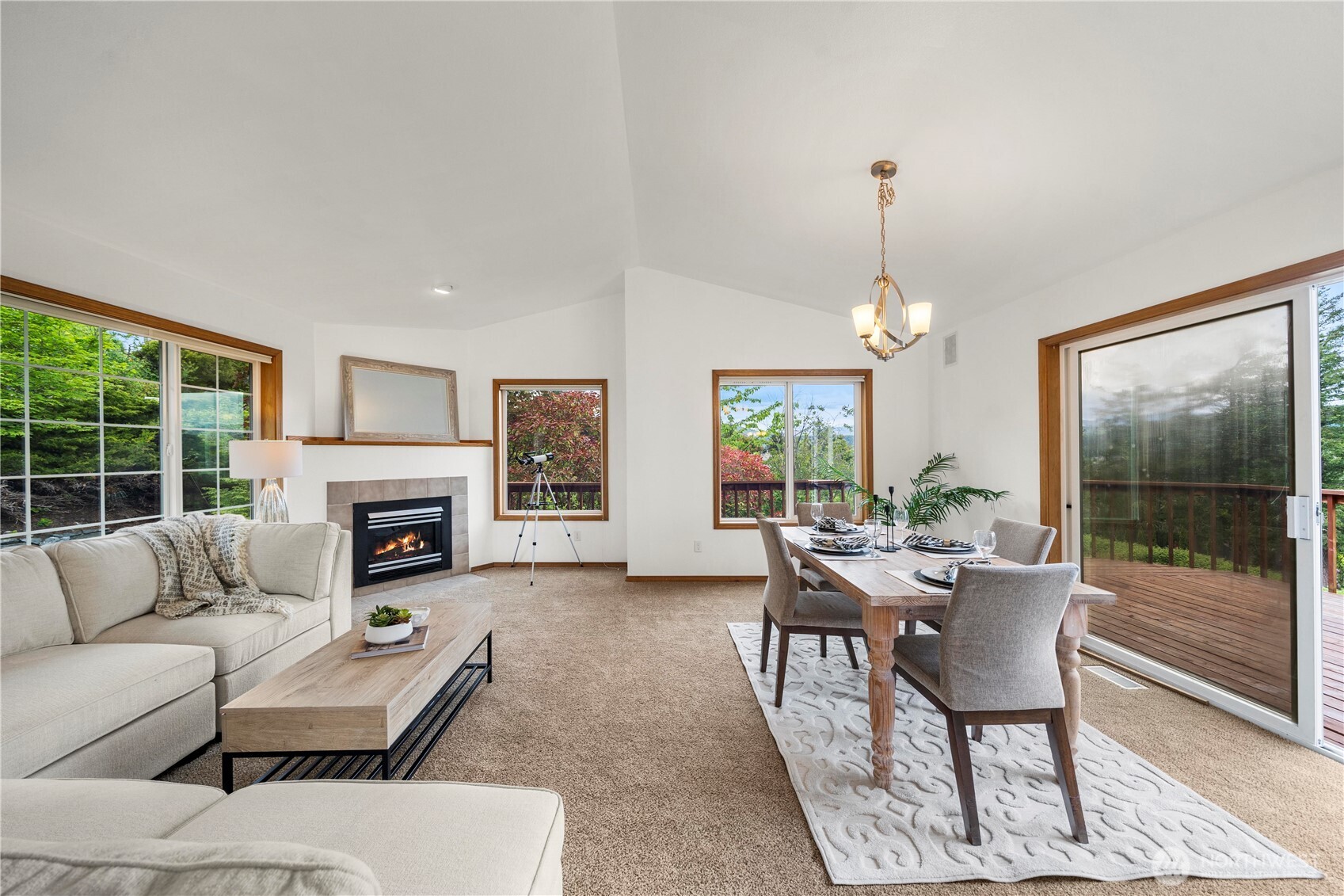 183 Dow Ridge Drive North Eatonville, WA 98328 - Photo 7 of 40 a living room with furniture a fireplace and a chandelier