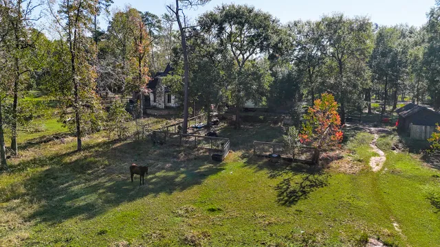 a backyard of a house with a yard and outdoor seating