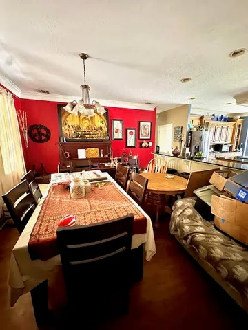 a bed room with two bed and a chandelier