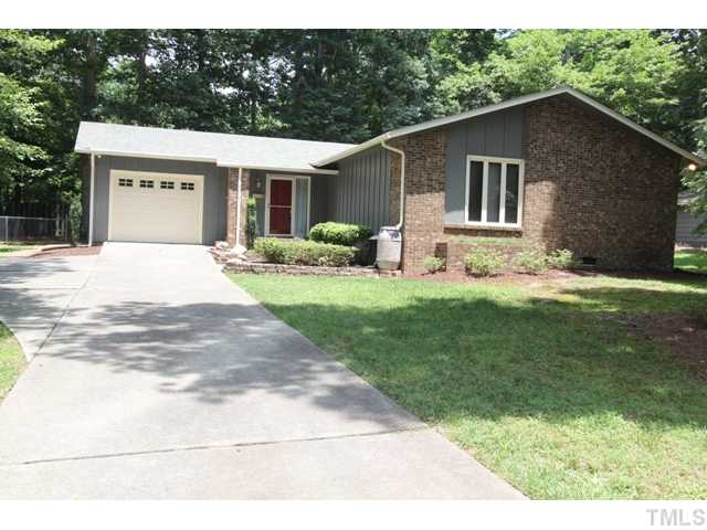 8616 Brandon Station Road Raleigh, NC 27613 - Photo 1 of 18 a front view of a house with a garden