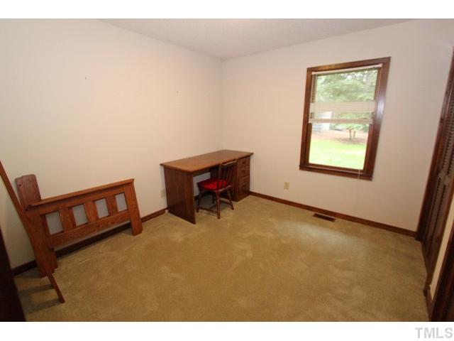 8616 Brandon Station Road Raleigh, NC 27613 - Photo 13 of 18 a room with furniture and a window
