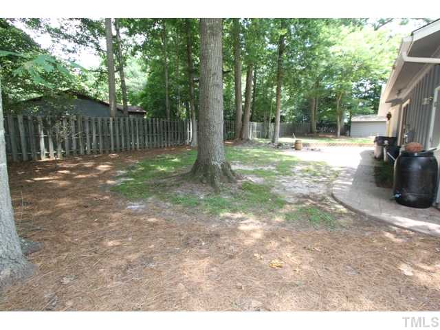 8616 Brandon Station Road Raleigh, NC 27613 - Photo 16 of 18 a view of a backyard with trees