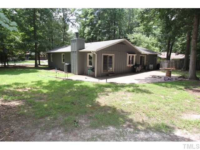 8616 Brandon Station Road Raleigh, NC 27613 - Photo 18 of 18 a front view of a house with a yard and trees