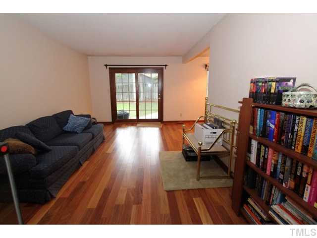 8616 Brandon Station Road Raleigh, NC 27613 - Photo 5 of 18 a living room with furniture and a book shelf
