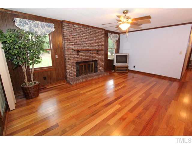 8616 Brandon Station Road Raleigh, NC 27613 - Photo 8 of 18 a living room with furniture and a fireplace