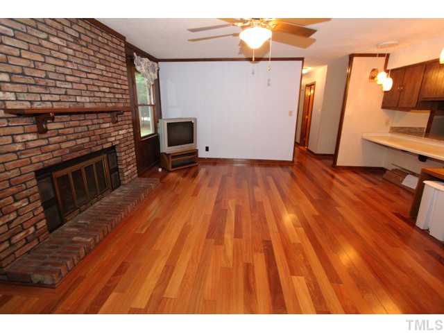 8616 Brandon Station Road Raleigh, NC 27613 - Photo 9 of 18 a view of a livingroom with wooden floor and staircase