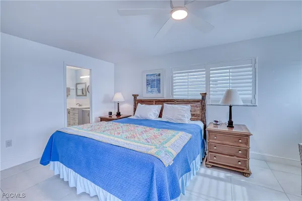 a bedroom with a bed and a night stand