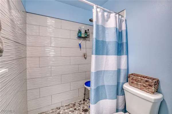 a bathroom with a toilet and shower
