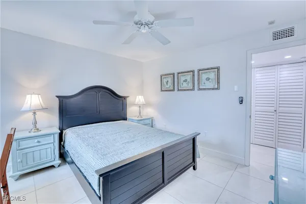 a bedroom with a bed and a night stand