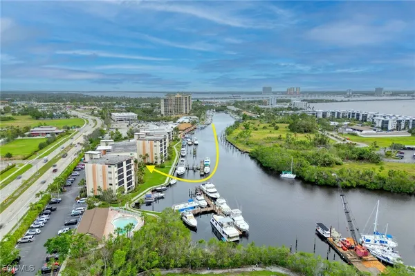 an aerial view of a house with a garden and lake view