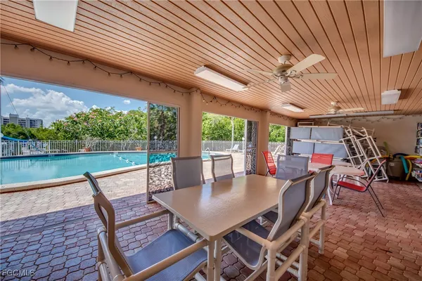 a view of a patio with a table chairs and a backyard